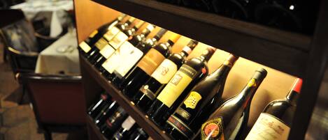A wine rack with various bottles of wine.