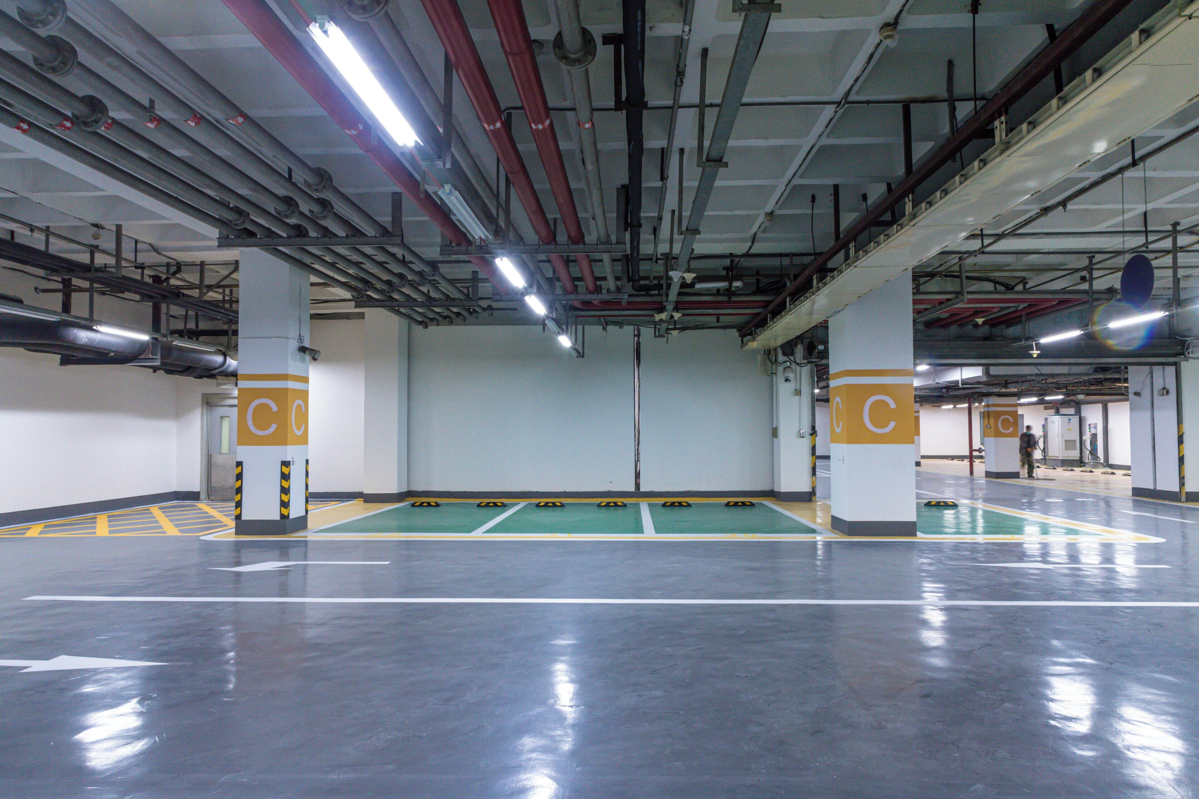 A parking garage with multiple levels, visible structural beams, and columns marked with 'C'.