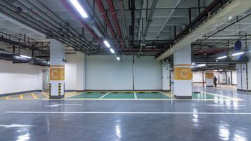 A parking garage with multiple levels, visible structural beams, and columns marked with 'C'.