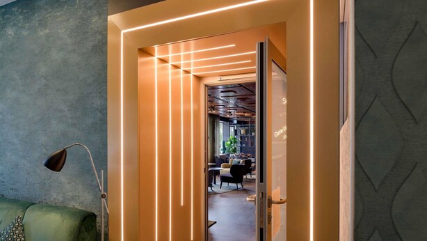 An interior view of a restaurant with a neon sign reading 'Eat & Drink' and a modern interior design. - Mercure Hotel Köln Belfortstraße (Cologne)