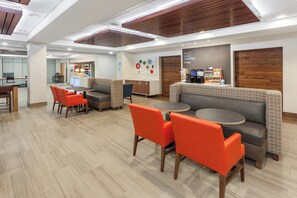 A modern hotel lobby with seating areas, a reception desk, and a coffee station. - Holiday Inn Express Hotel & Suites Providence-Woonsocket by IHG (Woonsocket)