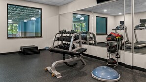 A gym with exercise equipment, a bench, a weight rack, and a treadmill. - Holiday Inn Express New Haven by IHG (New Haven)