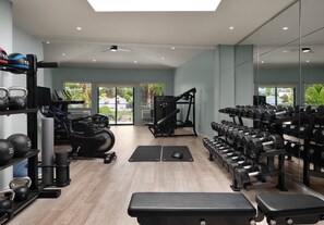 A gym with exercise equipment, a treadmill, and a bench. - voco Solana Beach-Del Mar by IHG (Solana Beach)