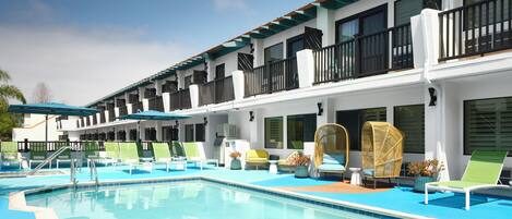 A poolside area with lounge chairs and a swimming pool.