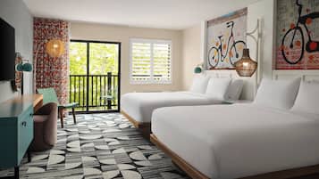 A hotel room with two beds, a desk, a chair, a patterned rug, and a balcony with a view of greenery.