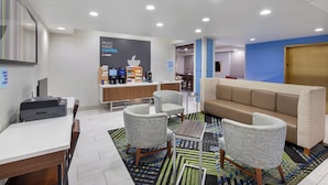 A modern hotel lobby with a coffee station, seating area, and a reception desk. - Holiday Inn Express Hotel and Suites Kings Mountain by IHG (Kings Mountain)