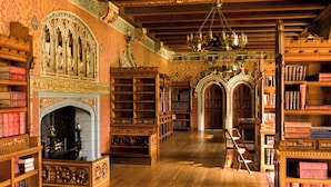 A library interior with ornate woodwork, bookshelves, and a fireplace. - Holiday Inn Express Cardiff Bay by IHG (Cardiff)