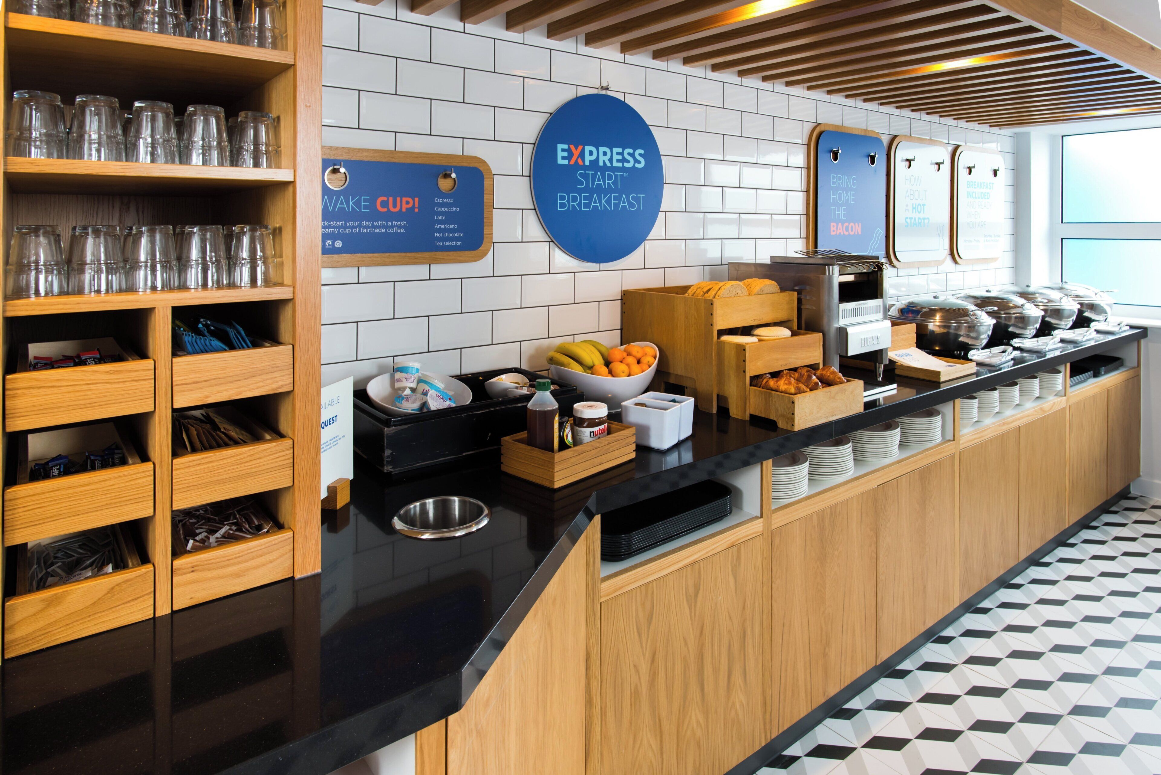A breakfast buffet area with a sign indicating 'EXPRESS START' and a variety of food options.