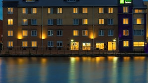 A multi-story Holiday Inn Express hotel with a brick facade, multiple windows, and a flat roof. - Holiday Inn Express Cardiff Bay by IHG (Cardiff)