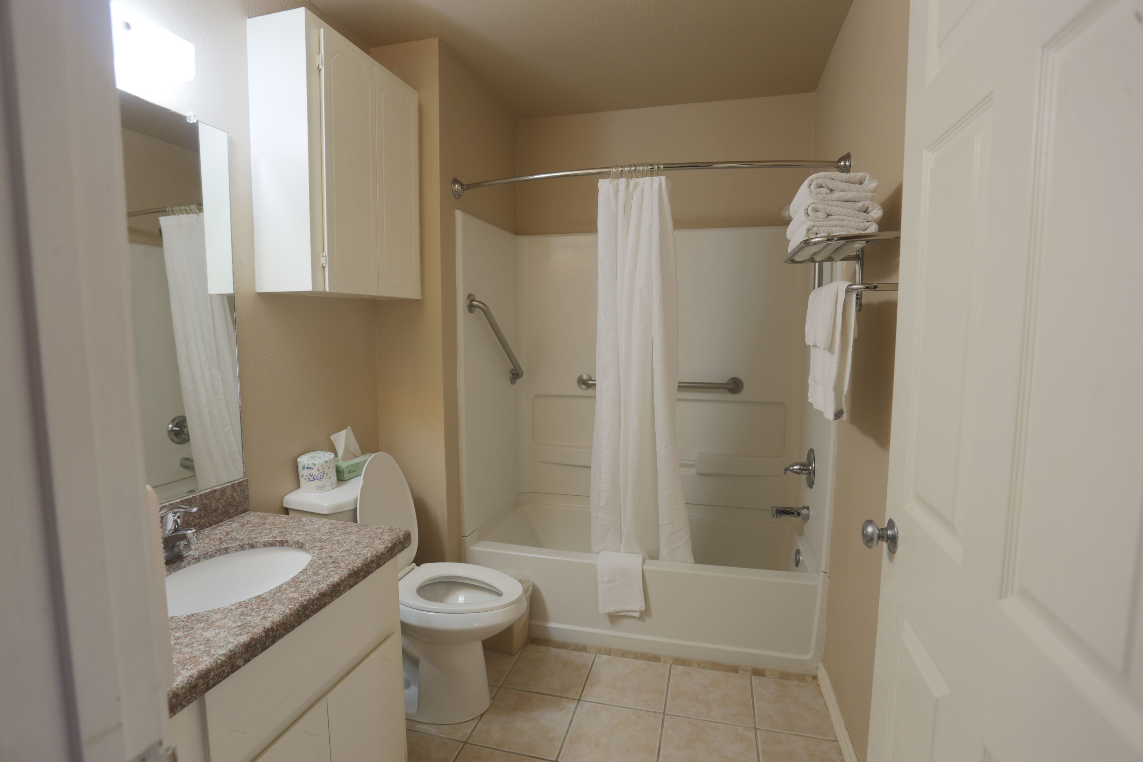 combined shower/bathtub, designer toiletries, hair dryer, towels