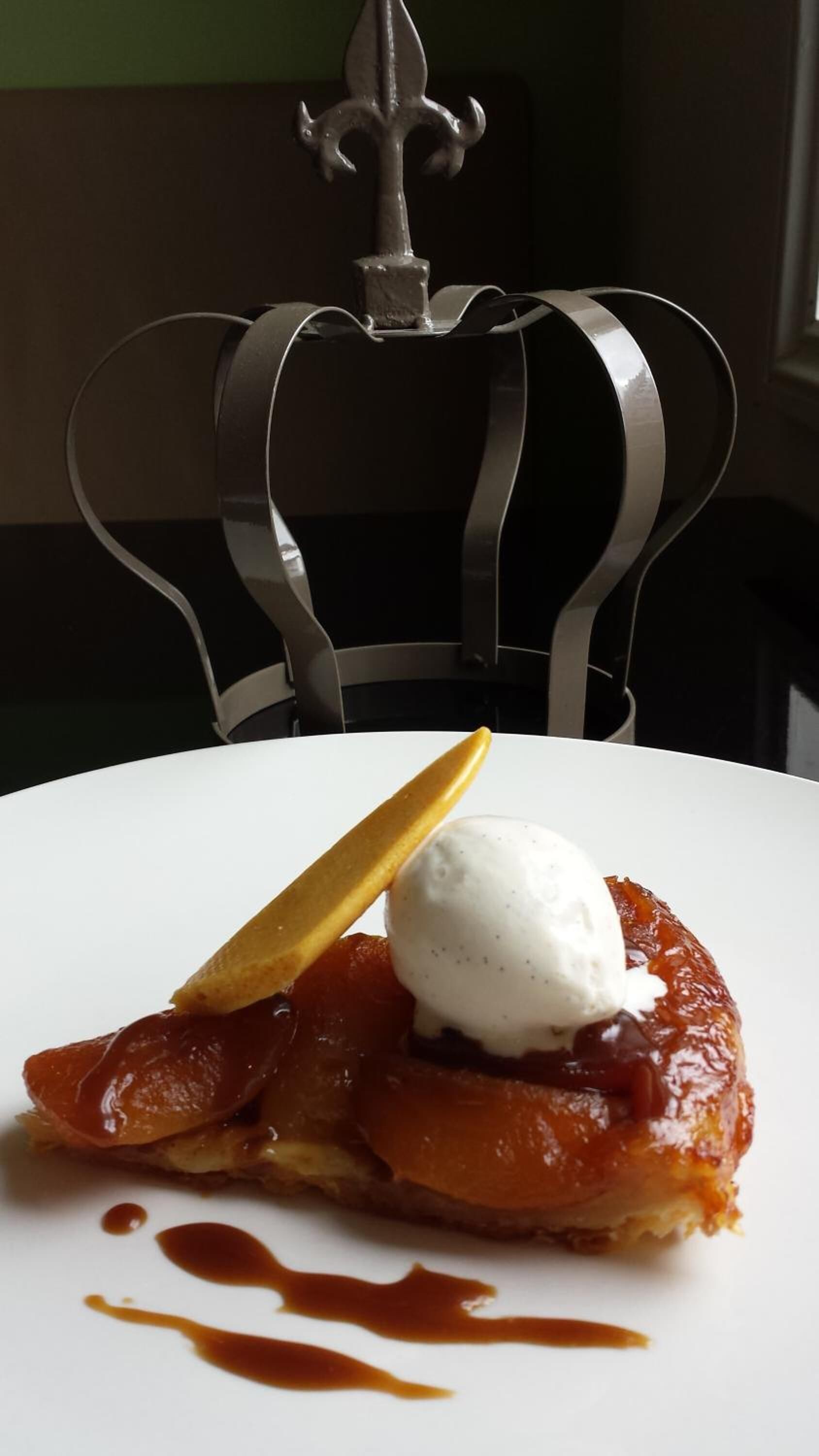 A dessert on a white plate with a caramel sauce drizzle.