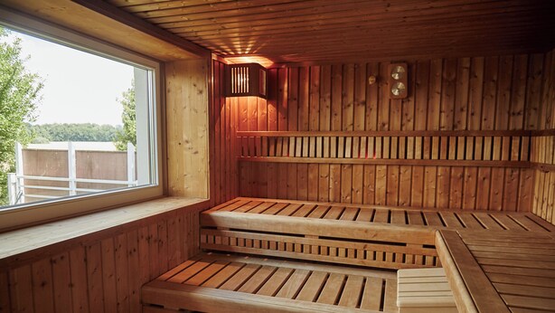 A sauna with wooden benches and a window.