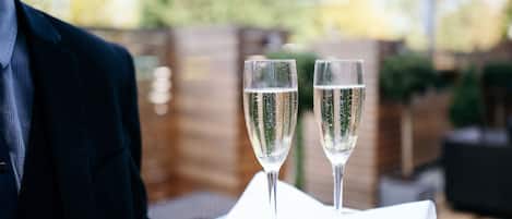 Two champagne flutes on a white napkin on a table.