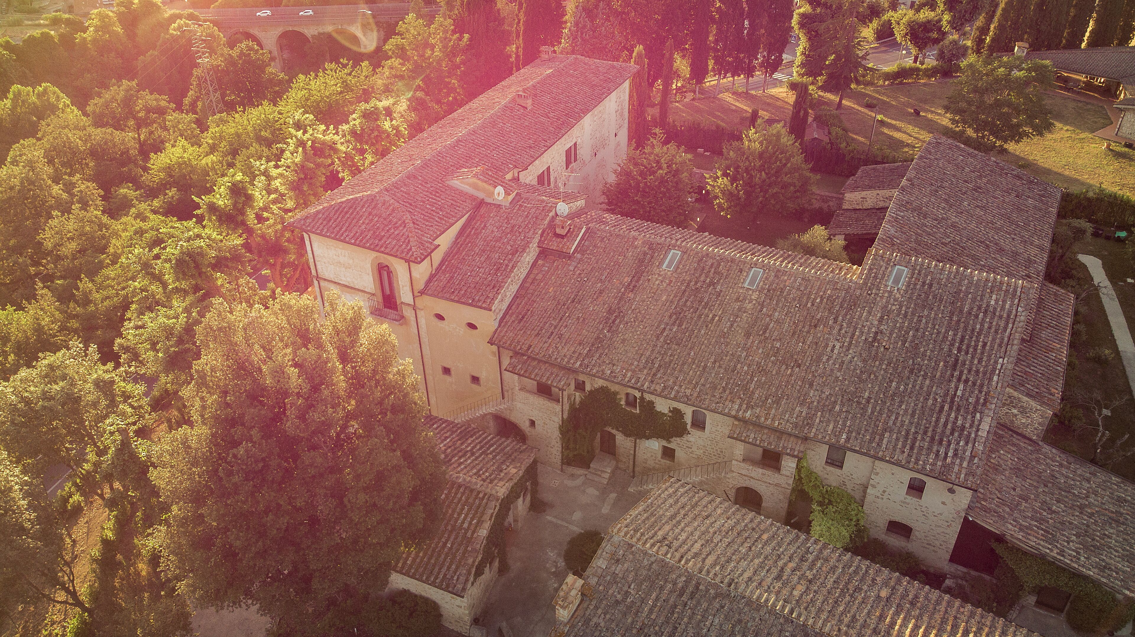 An aerial view of a historic building with multiple roofs and a courtyard.
