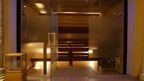 A modern elevator with a glass door, a wooden floor, and a metal railing. - Romantik Hotel die Gersberg Alm mit Panorama über Salzburg und Outdoorpool ab Mai (Salzburg)