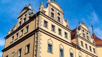 A multi-story building with classical architecture, including ornate window frames and decorative elements.