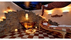 A room with a checkered floor, a vintage bathtub, and a bed with a red canopy. - Lohmann's Romantik Hotel Gravenberg (Langenfeld)