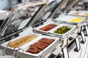A buffet with various food items in glass containers, including what appears to be pastries and dips. - Hilton Hurghada Plaza (Hurghada)