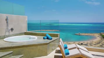 Relax in style with a bathtub and glass-enclosed shower, offering a stunning beach view.