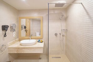 A modern bathroom with a glass-enclosed shower, a sink with a mirror, and a hairdryer on the wall. - Safir Sharm Waterfalls Resort (Sharm El Sheikh)