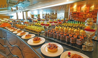 A buffet with various desserts and pastries.