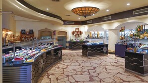 A buffet area with multiple food stations and a central fire feature. - Safir Sharm Waterfalls Resort (Sharm El Sheikh)