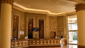 A lobby with a reception desk, columns, and a tiled floor. - Safir Sharm Waterfalls Resort (Sharm El Sheikh)