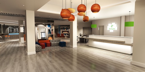A modern hotel lobby with a reception desk, seating area with colorful cushions, and a kitchen in the background. - Holiday Inn Corby Kettering Hotel & Spa (Corby)