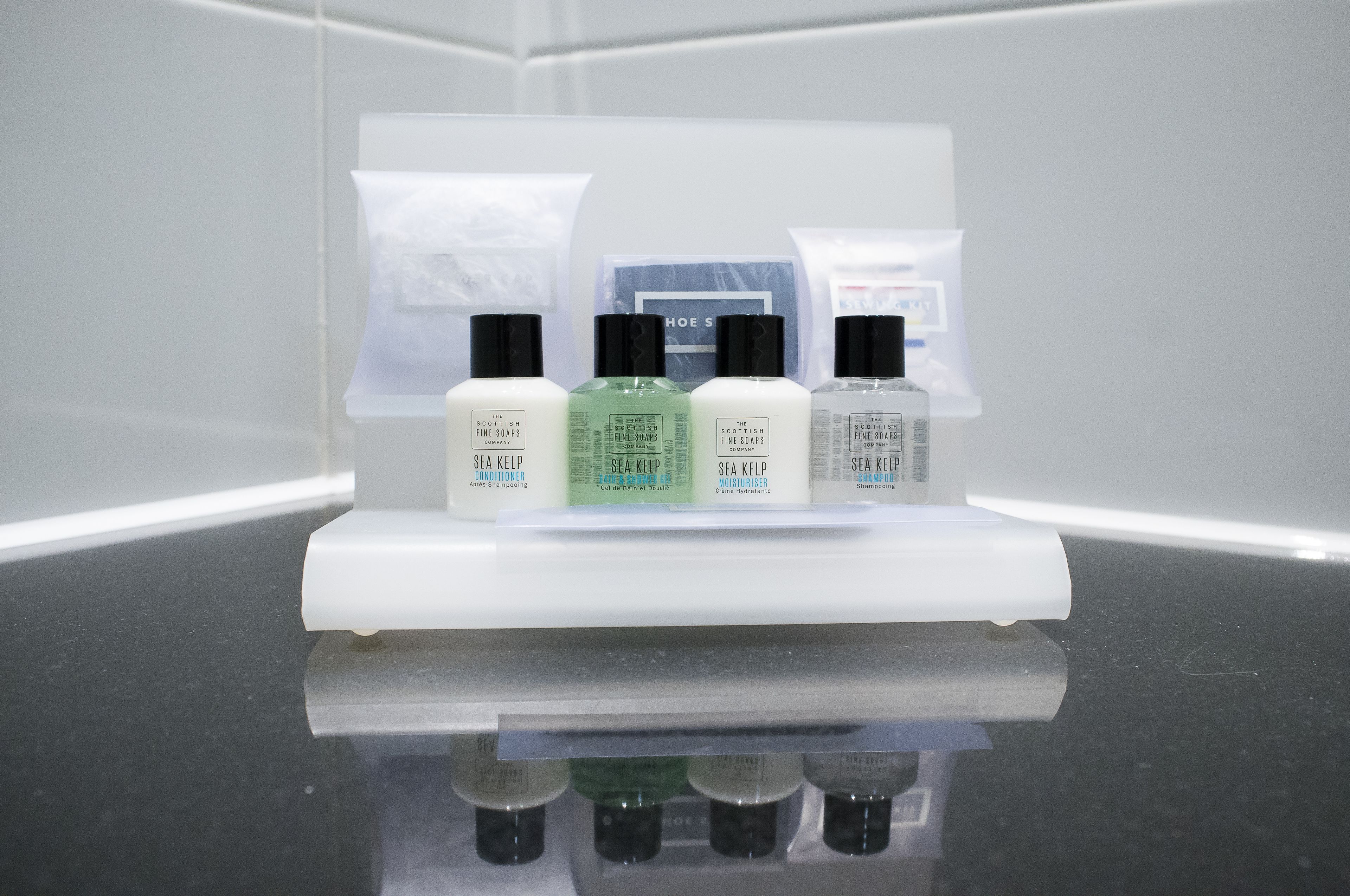A display of skincare products on a white stand.