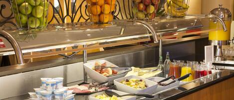 A buffet with various food items and beverages.