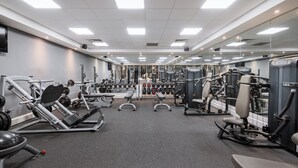 A gym with various exercise equipment, mirrors, and a weight rack. - Holiday Inn Glasgow East Kilbride by IHG (Glasgow)