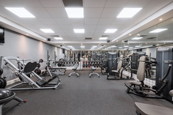 A gym with various exercise equipment, mirrors, and a weight rack. - Holiday Inn Glasgow East Kilbride by IHG (Glasgow)