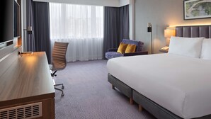 A hotel room with a large bed, a desk, a chair, and a television. - DoubleTree by Hilton Edinburgh Airport (Newbridge)