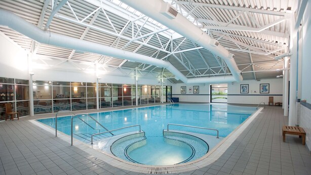 An indoor swimming pool with a high ceiling and large windows. - DoubleTree by Hilton Edinburgh Airport (Newbridge)