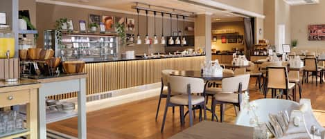 A modern restaurant with a bar area, wooden furniture, and a variety of seating options.