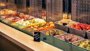 A buffet with various food options including beef noodle salad.