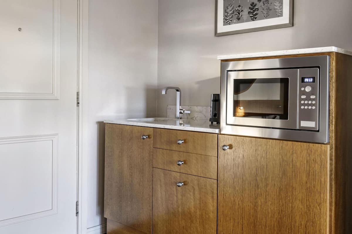 junior suite, fireplace | in-room safe, blackout curtains, iron/ironing board