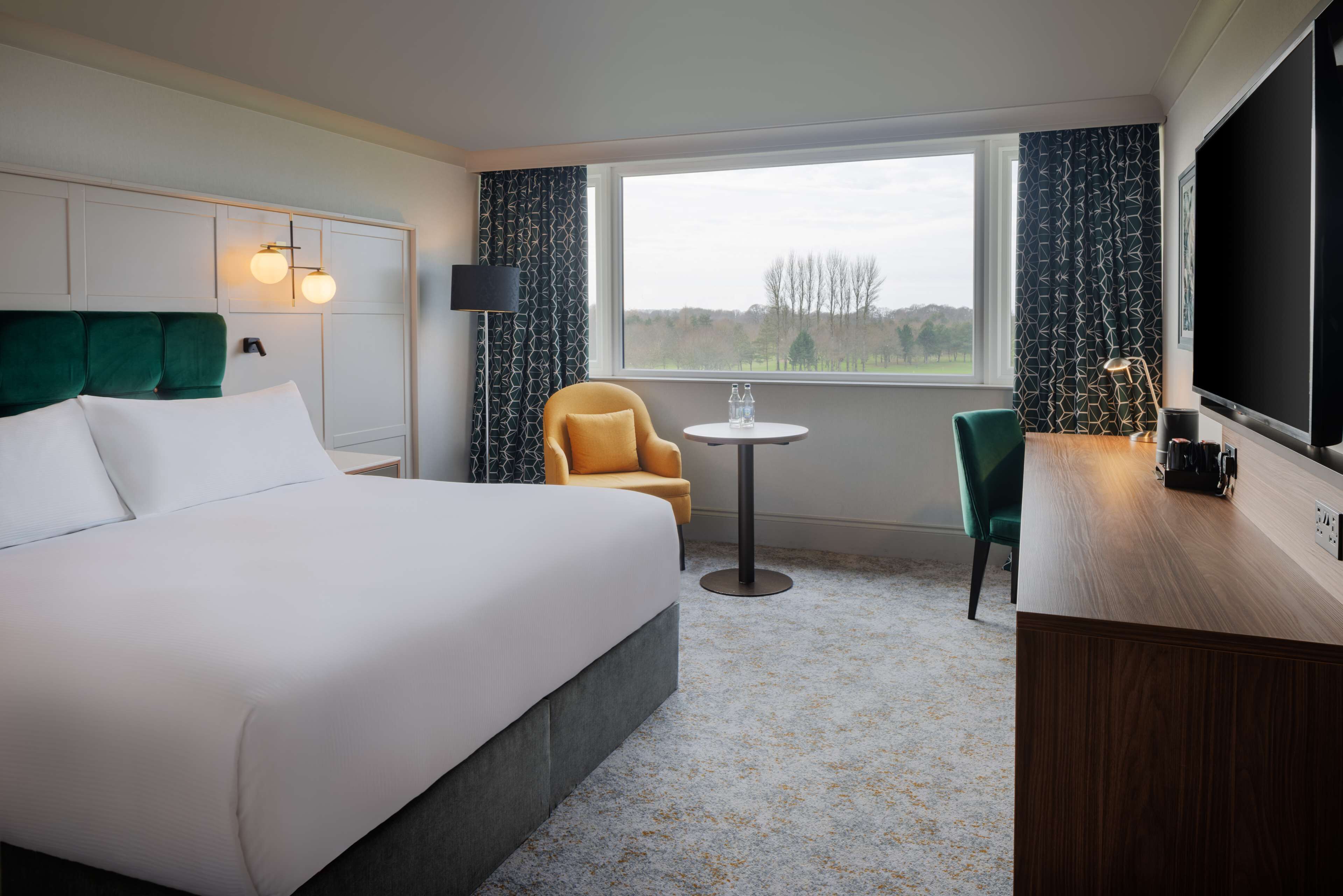 deluxe room, 1 king bed, golf view | in-room safe, desk, laptop workspace, blackout curtains