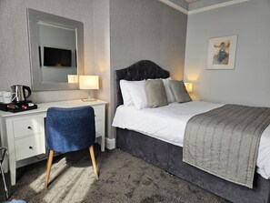 A hotel room with a bed, a desk, a chair, a bedside table with a lamp, a coffee maker, and a framed picture on the wall. - Best Western Stoke on Trent City Centre Hotel (Stoke-on-Trent)