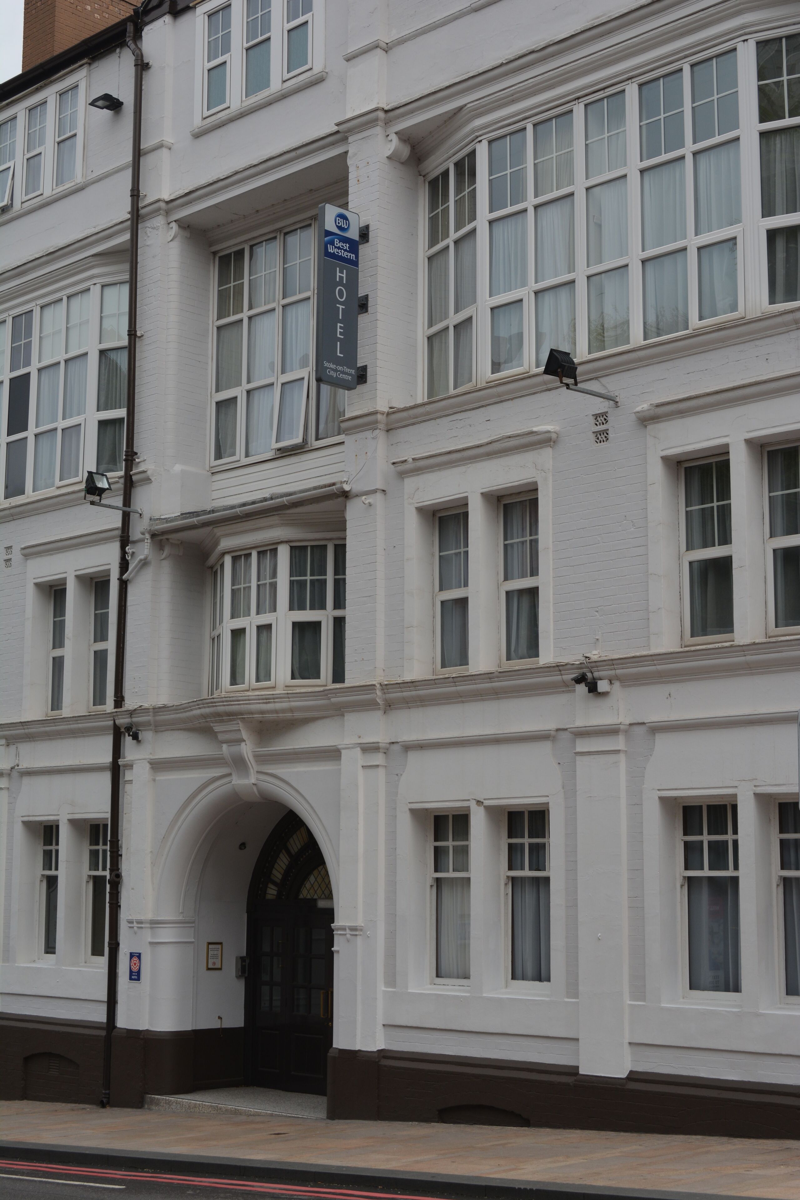 A multi-story hotel with a classic architectural style, featuring large windows and a prominent entrance with an archway.
