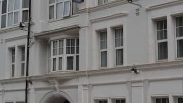 A multi-story hotel with a classic architectural style, featuring large windows and a prominent entrance with an archway.