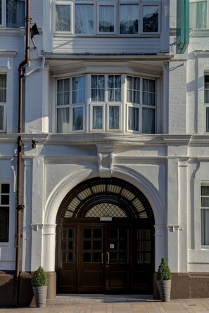 A building with a prominent arched entrance, large windows, and a brick facade. - Best Western Stoke on Trent City Centre Hotel (Stoke-on-Trent)
