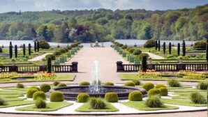 A formal garden with a central fountain, symmetrical pathways, and neatly trimmed hedges. - Best Western Stoke on Trent City Centre Hotel (Stoke-on-Trent)