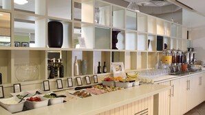 A buffet setup with various food items and beverages. - DoubleTree by Hilton Glasgow Strathclyde (Bellshill)