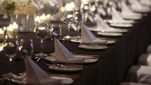 A long dining table set with multiple place settings, including plates, glasses, and napkins. - DoubleTree by Hilton Glasgow Strathclyde (Bellshill)