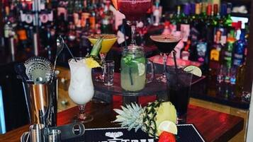 A bar area with various drinks and a sign that reads "FEVER TREE".
