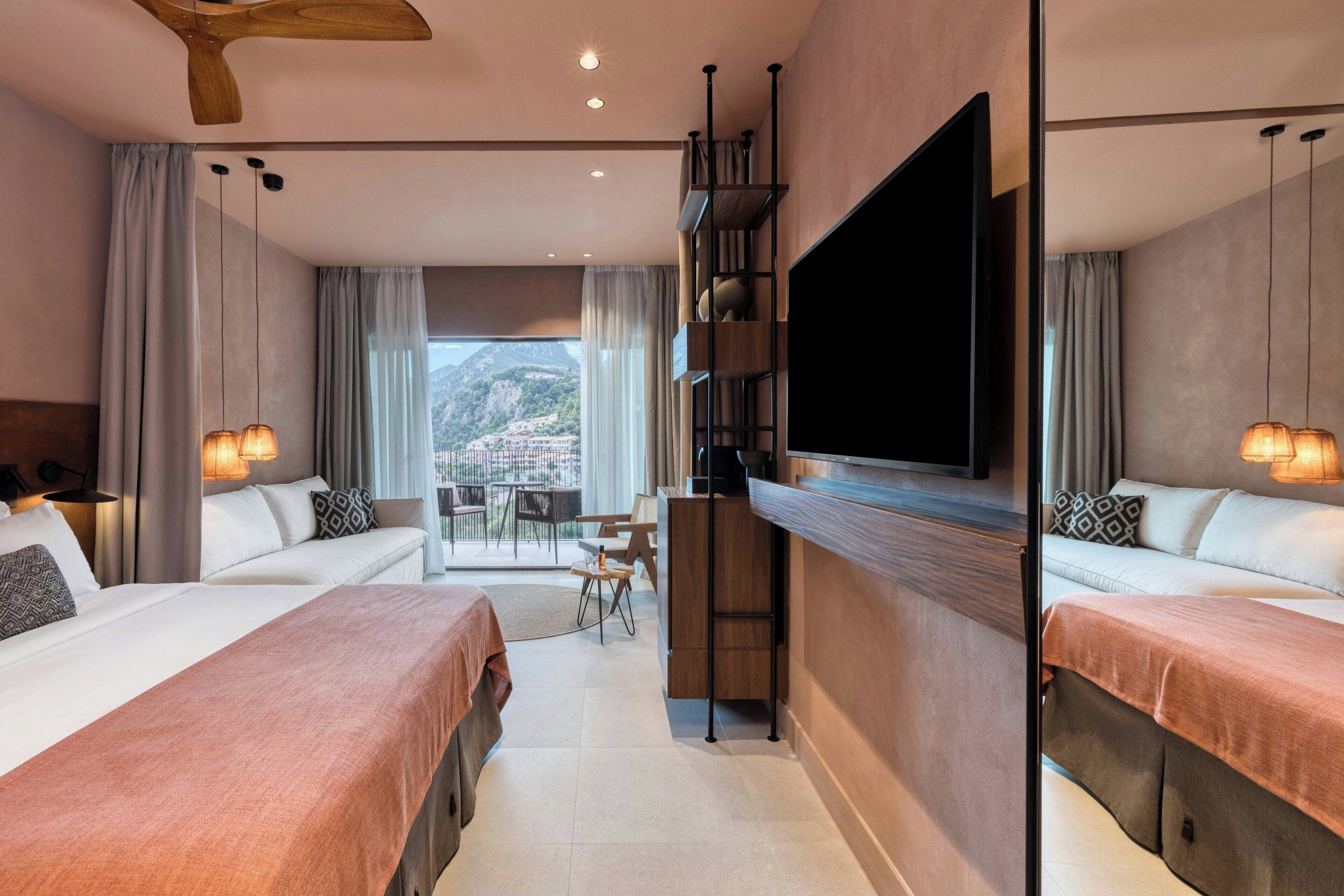 A modern hotel room with two beds, a TV, a balcony, and a dining area.