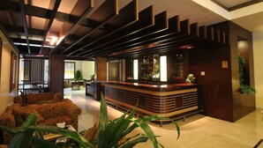 A lobby with a reception desk, seating area, and a bar. - Casa D Or Hotel (Beirut)