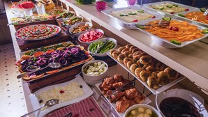 A buffet with various food items including salads, cheeses, and pastries. - Casa D Or Hotel (Beirut)