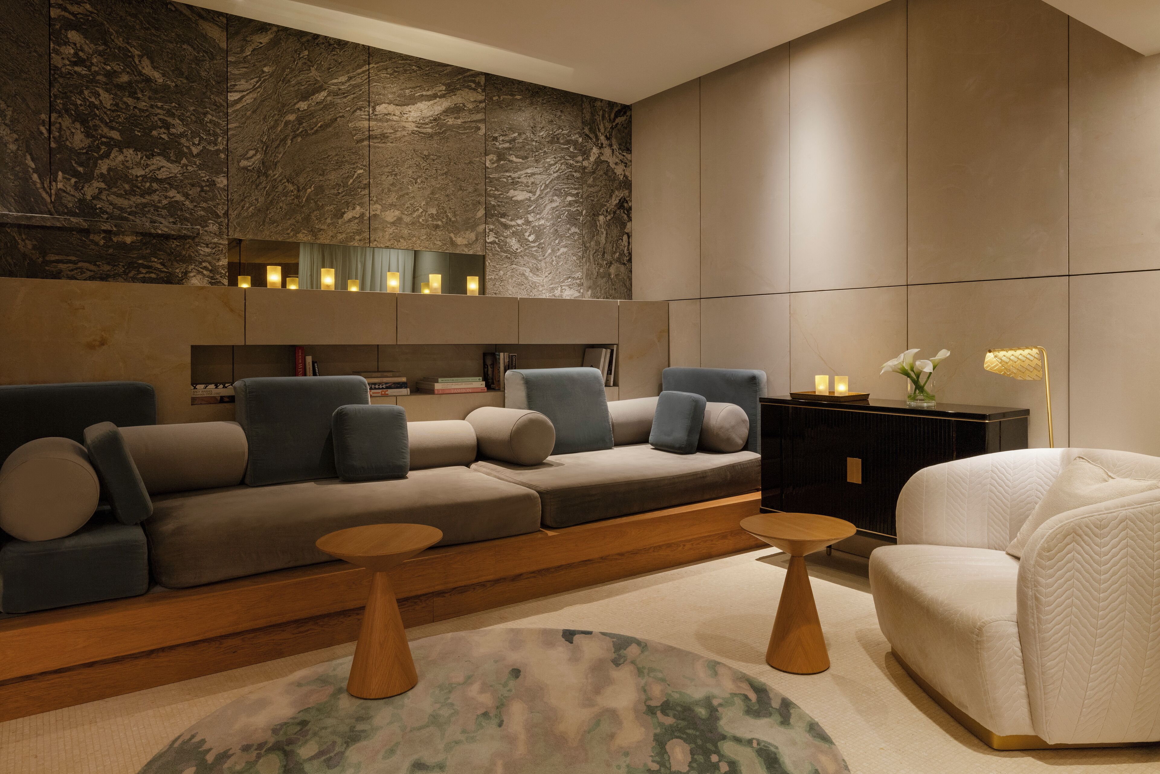 A modern living room with a sectional sofa, armchairs, and a coffee table.